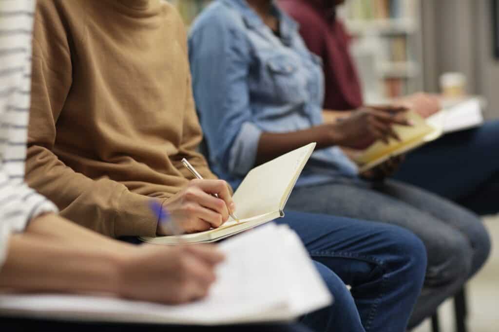 People writing at seminar